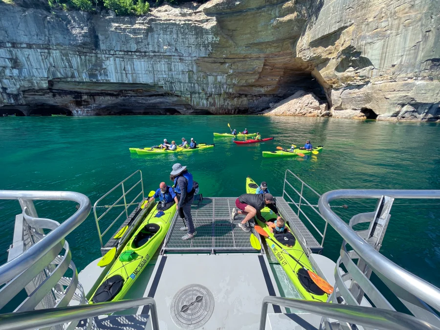 Getting in tandem kayaks on the Pictured Rocks Express with Pictured Rocks Kayaking